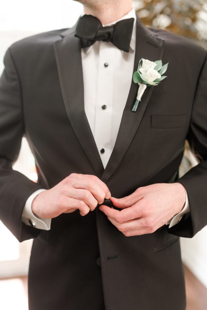 groom in black tuxedo with bowtie