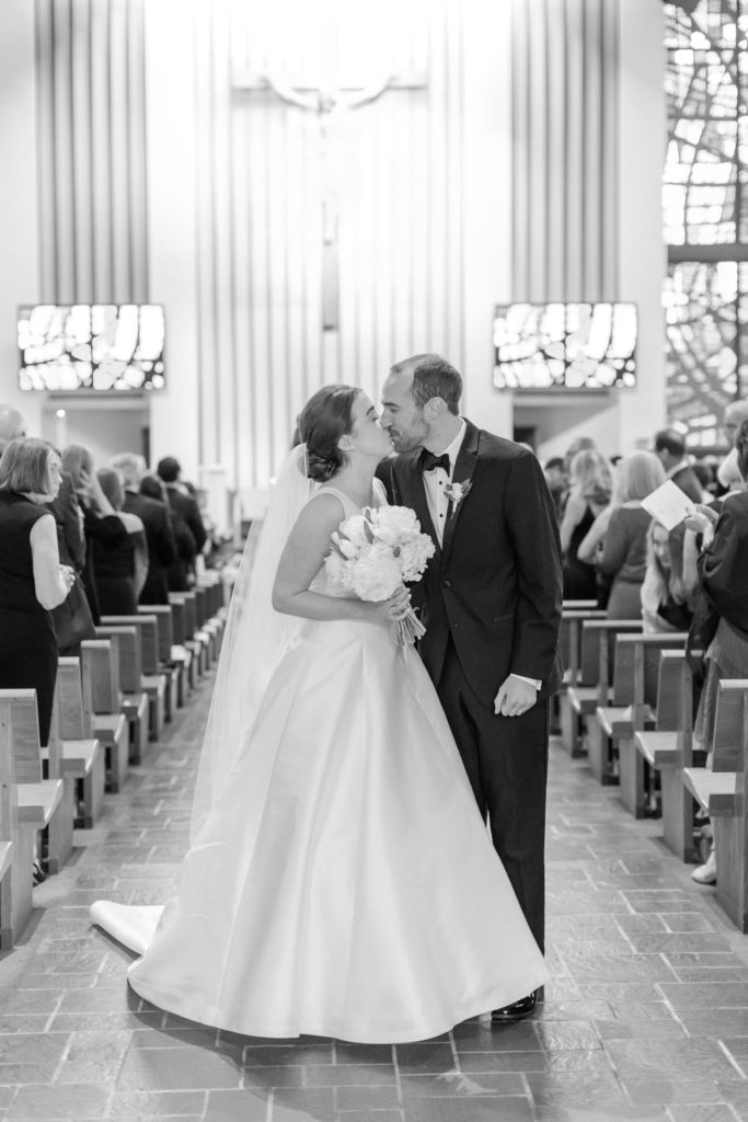 Bride and groom kissing at church wedding
