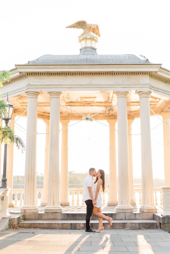 Couple kissing during golden hour engagement photos