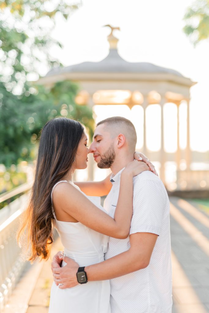 Couple kissing during golden hour engagement photos