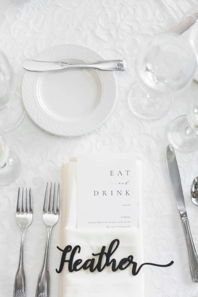 white wedding table with calligraphy name card