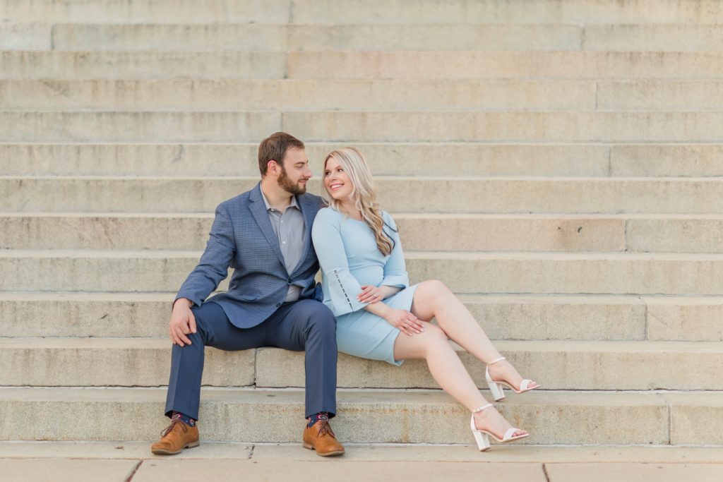 Couple snuggling on steps during enaggement photos