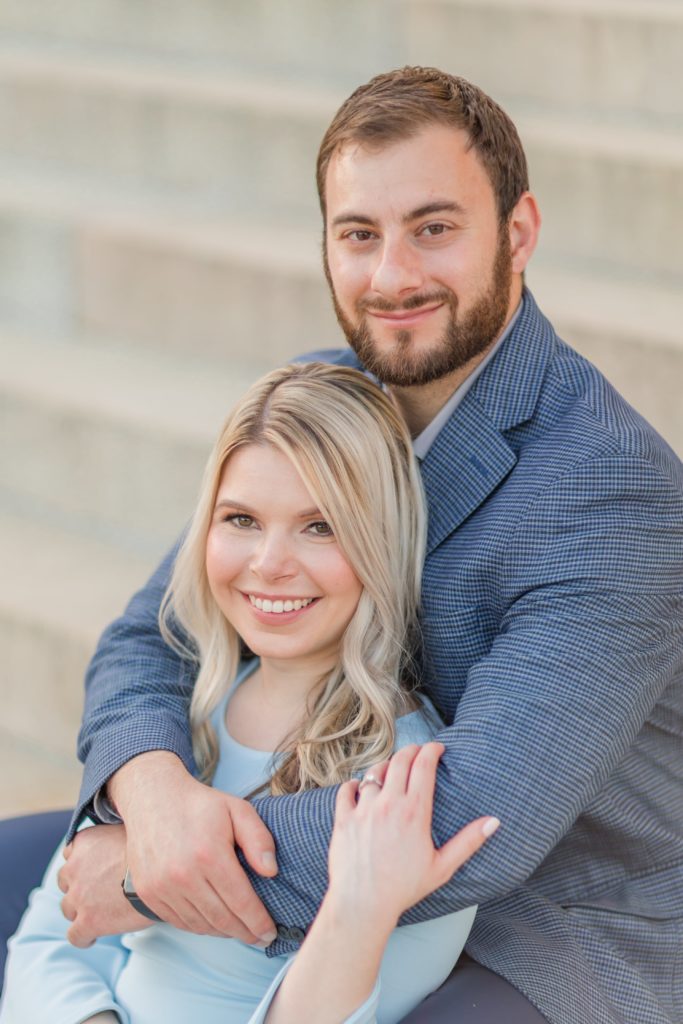 Couple snuggling on steps during Fairmount Park engagement session