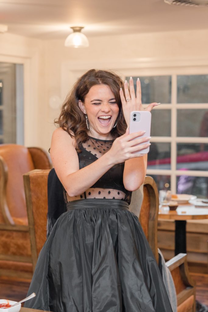 Girl showing engagement ring over factime