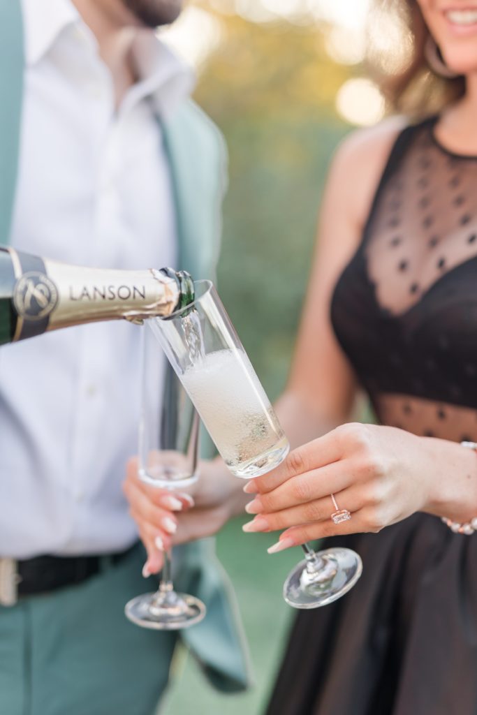 newly enaged couple pouring champagne