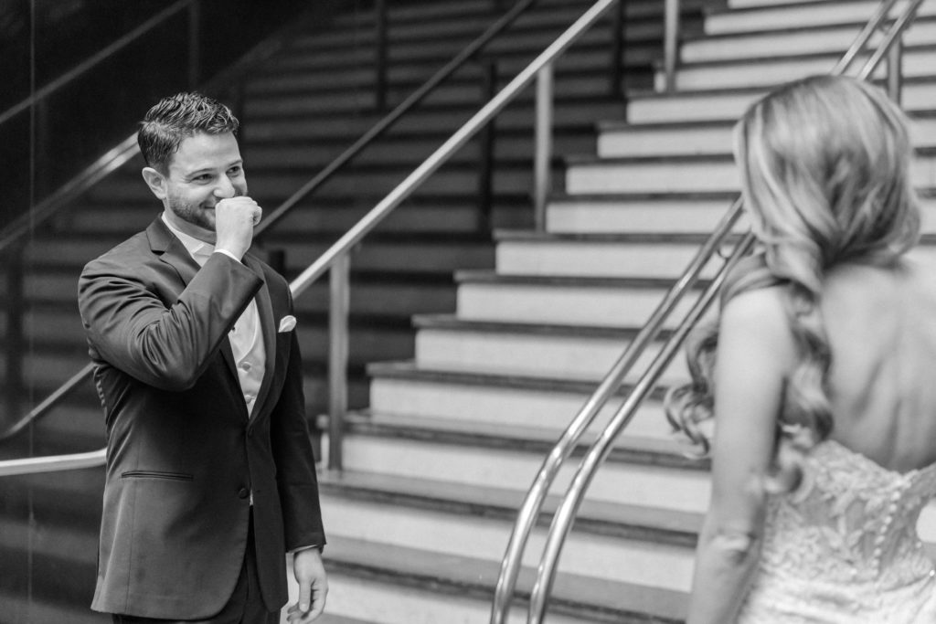 black and white photo of emotional groom during first look
