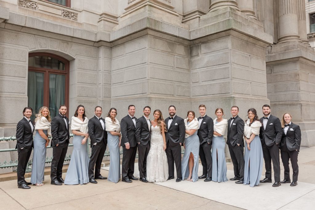 Wedding party in tuxedos and long blue gowns