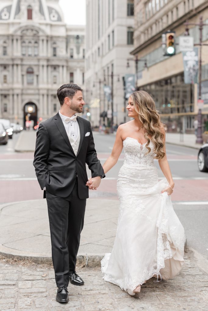 Bride and groom holding hands in Philadelphia City Hall Wedding Photos