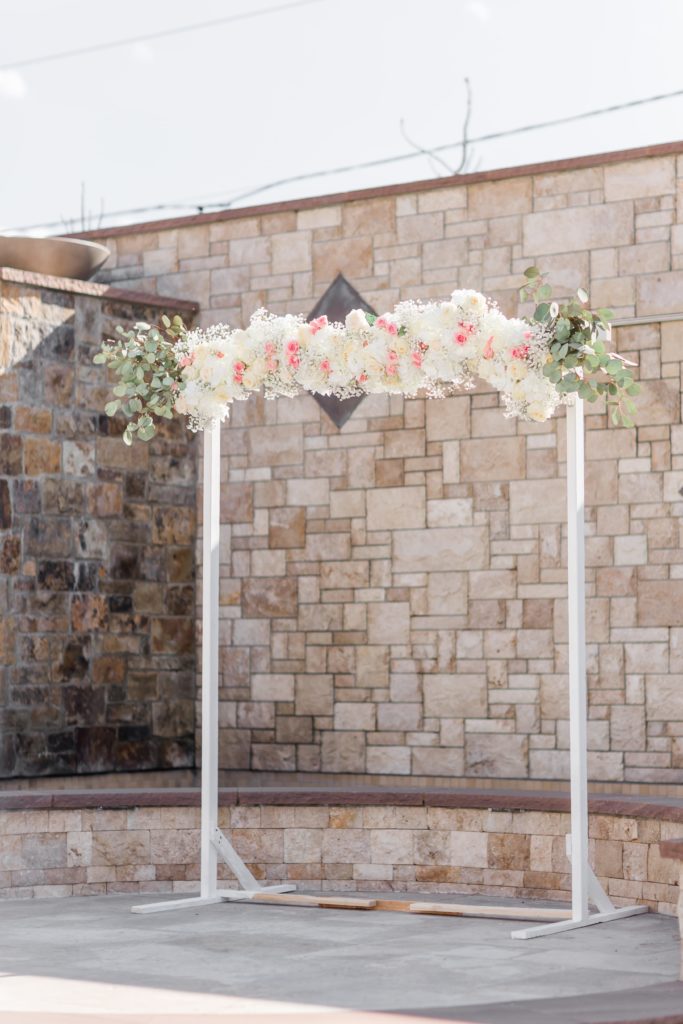 Wedding ceremony arch with pink and white flowers