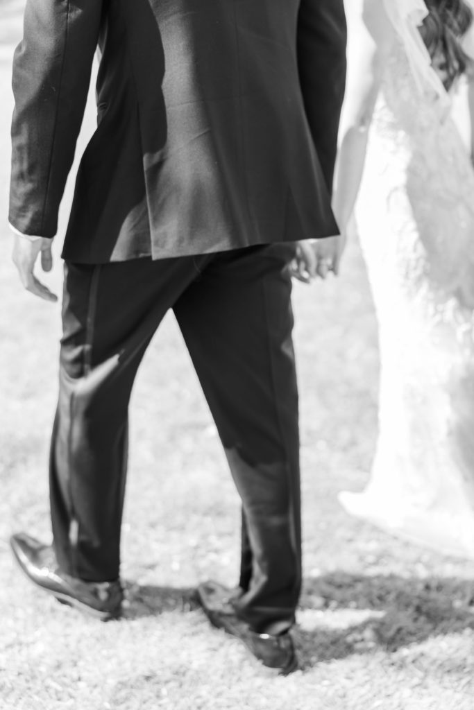 Black and white photo of New Jersey bride and groom holding hands