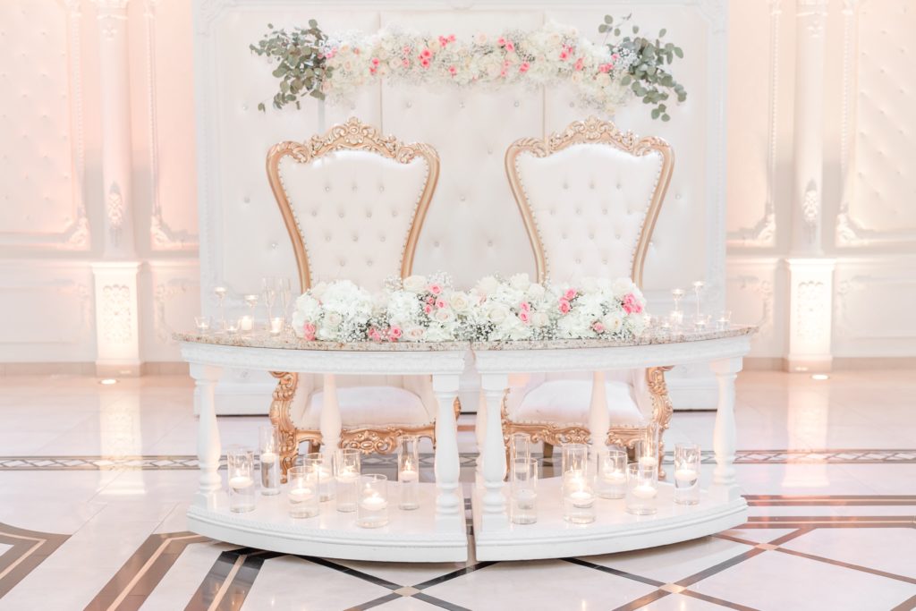 Sweetheart table with white and gold chairs