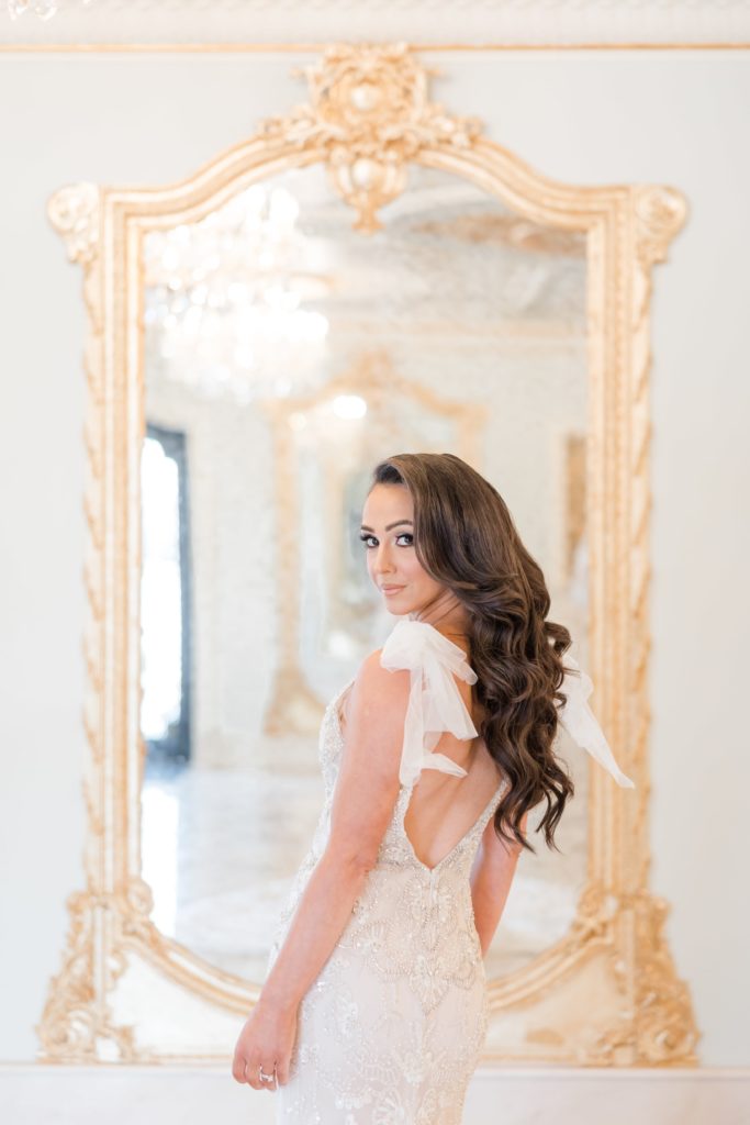 Bride in front of gold mirror
