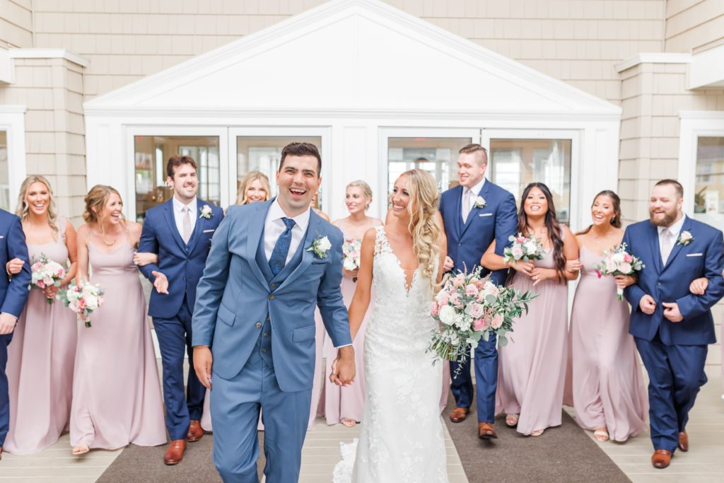 wedding party in blue suits and pink dresses
