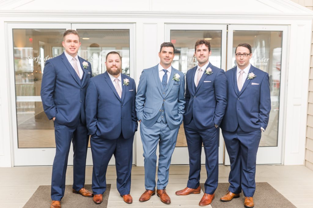 Groom with groomsmen in navy blue suits