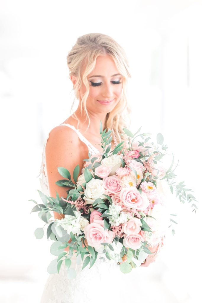 Bride holding pink and white flowers