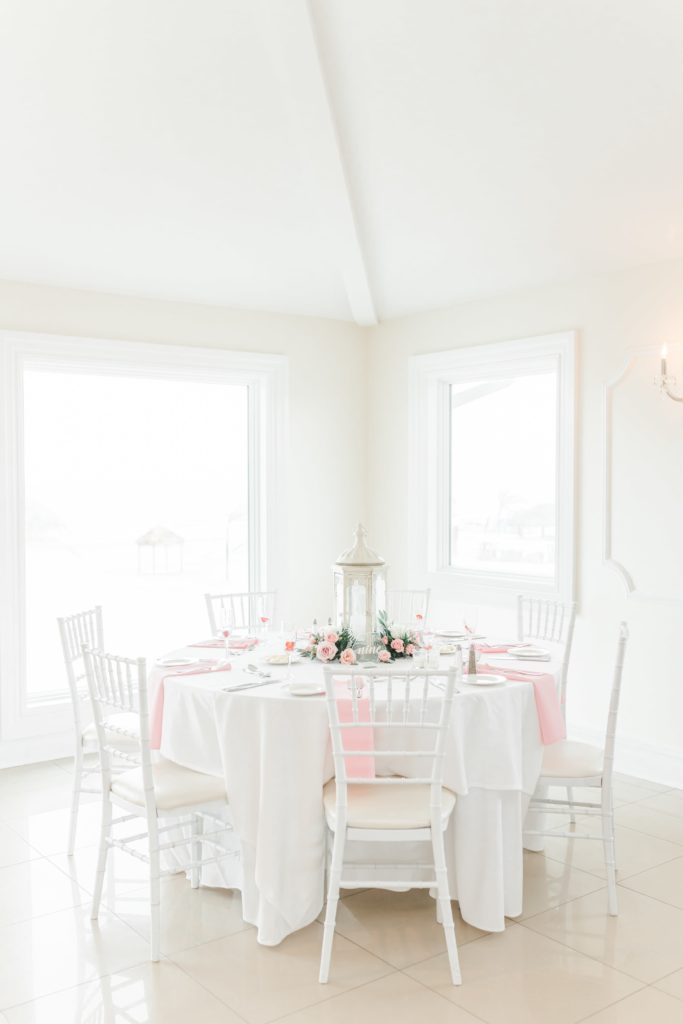 White wedding tables with pink linens