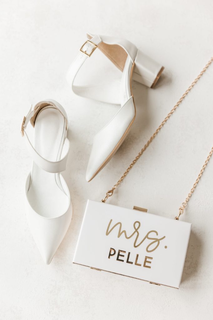 White wedding heels and bridal clutch