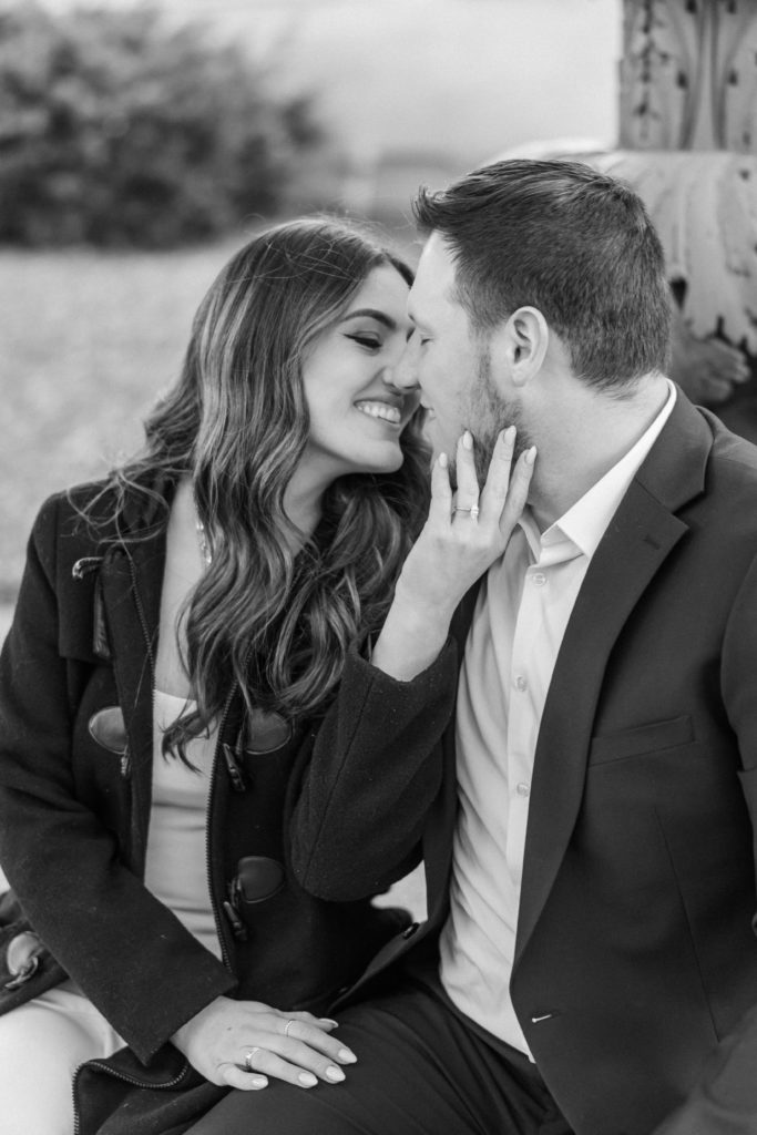 Black and white photo of engagd couple snuggling