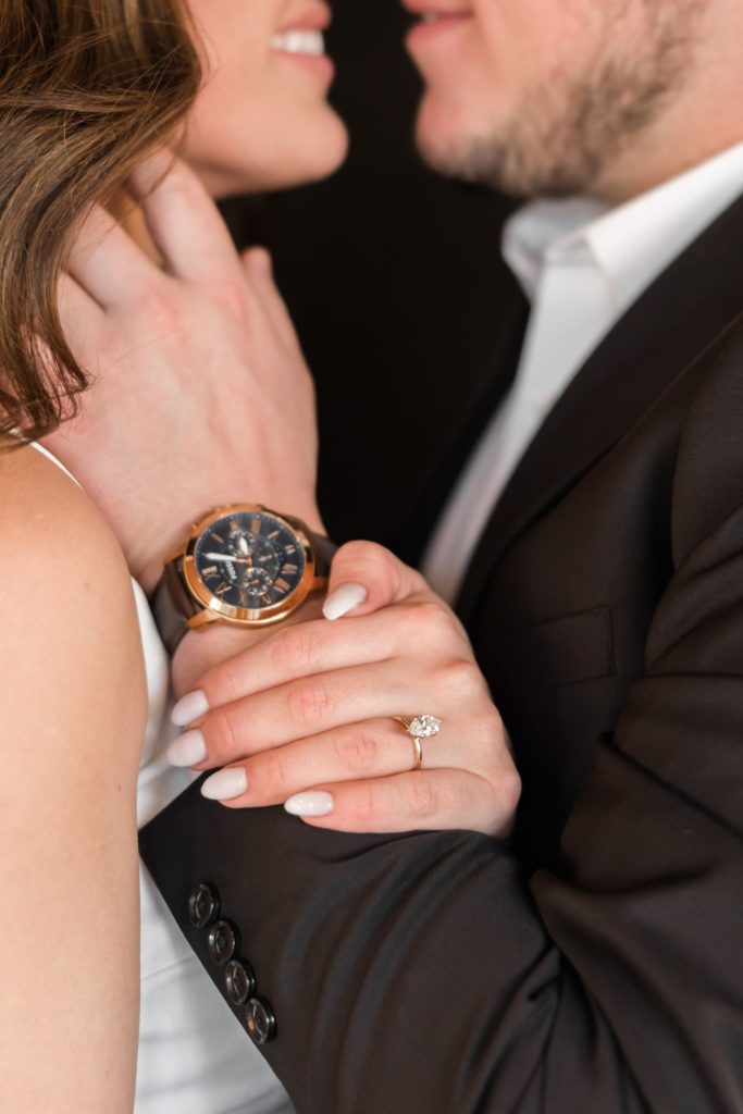 hands with engagement ring and guys watch