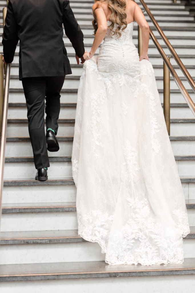 Bride and groom walking up mirror stairs