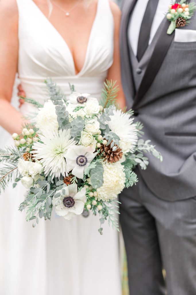 Winter bridal bouquet with white flowers and pine cones
