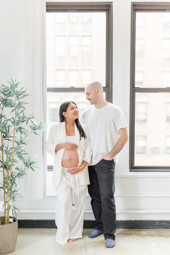 Mom and dad wearing white in maternity photos