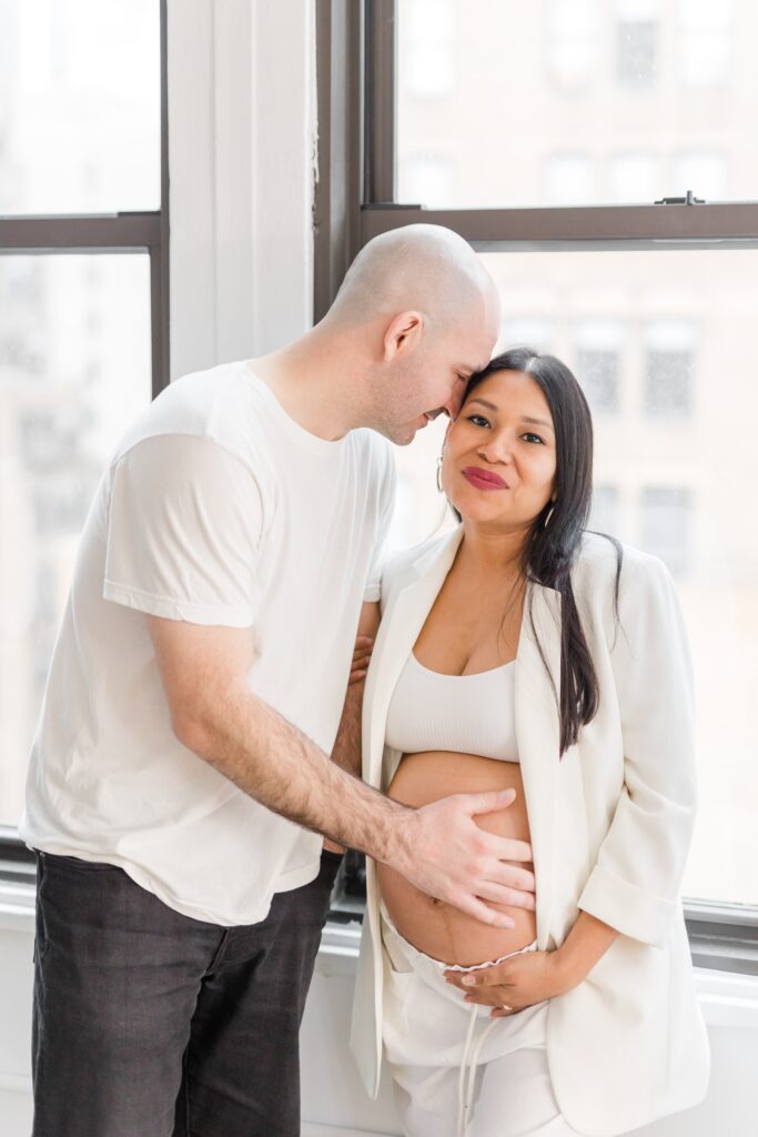 Maternity portraits of parents in white outfits