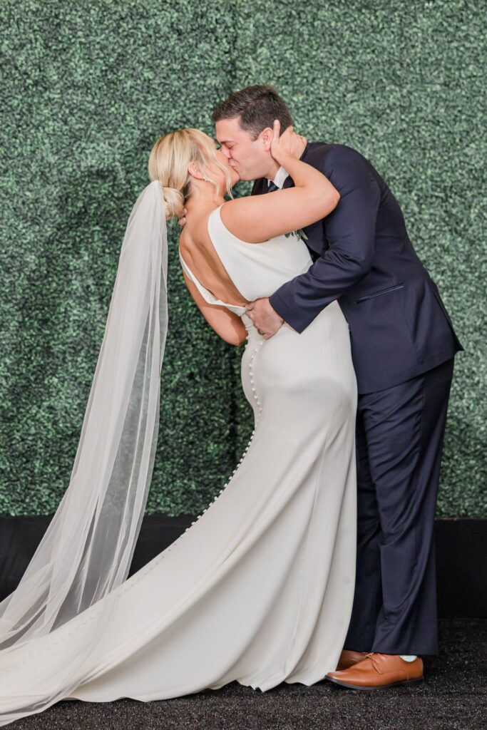 Bride and groom kissing during Philadelphia Cricket Club wedding ceremony