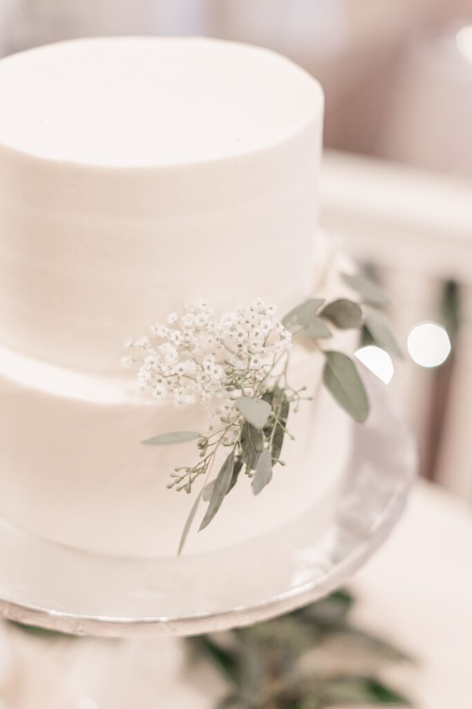 Small white wedding cake with white flowers