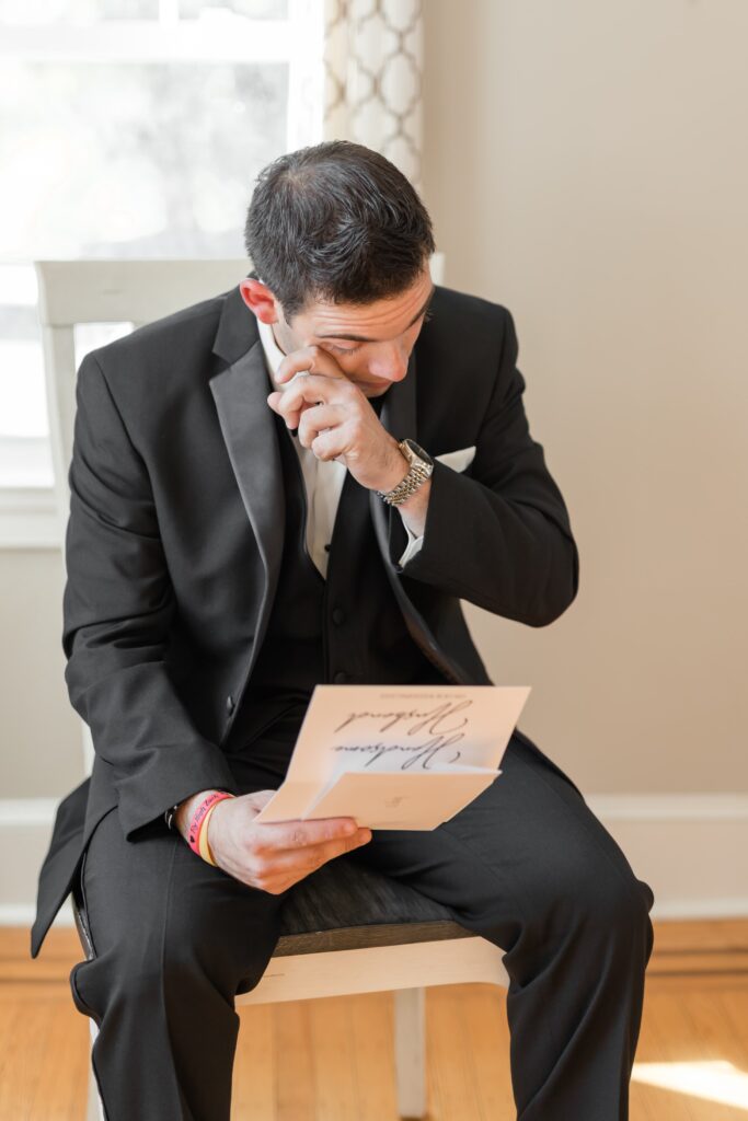 Groom crying and reading a letter
