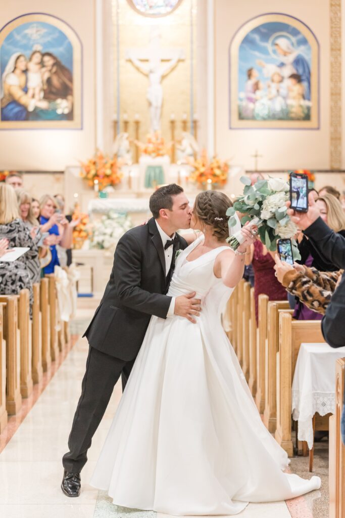 Bride and groom kissing in church