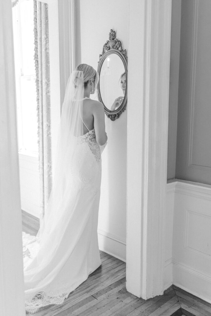 Black and white photo of bride in lace wedding dress