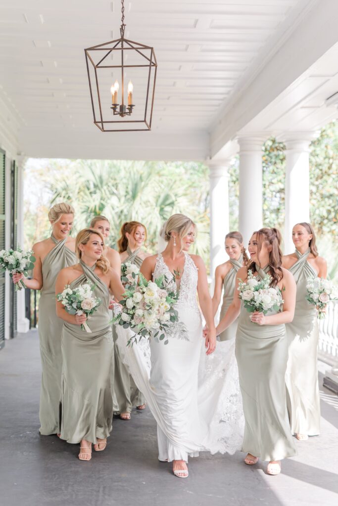 Bride with bridesmaids in sage green bridesmaid dresses