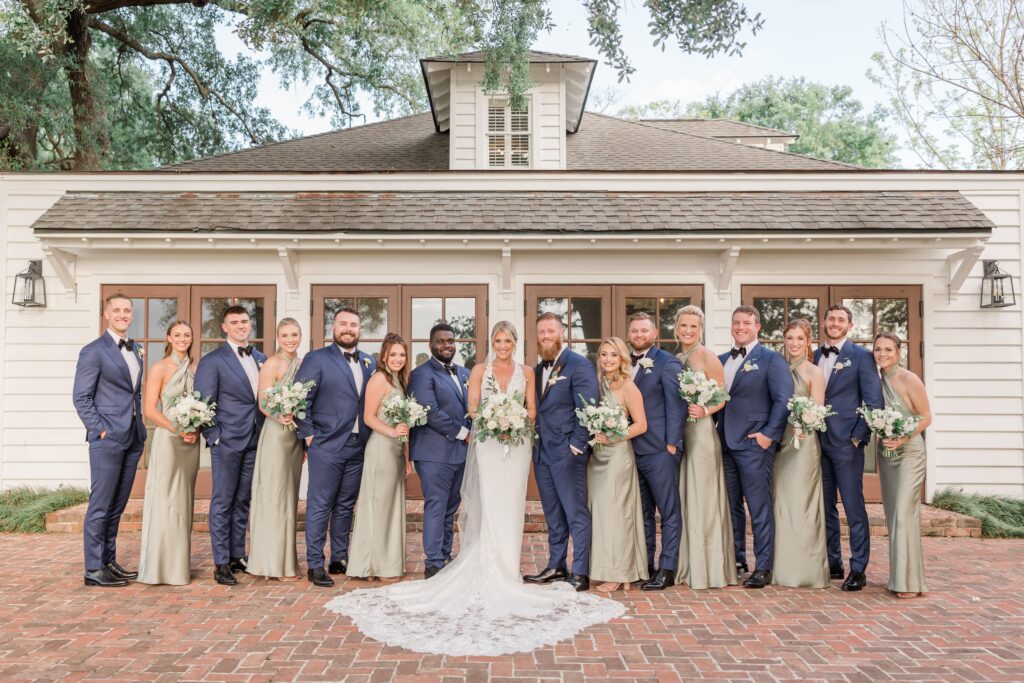 Wedding party in sage green and navy blue attire
