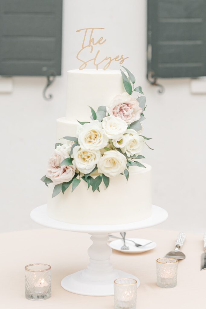 White wedding cake with white and pink flowers
