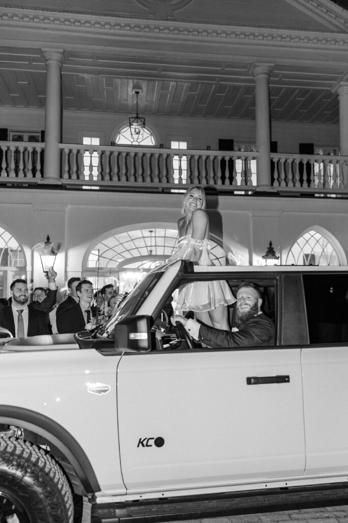 Bride and groom in wedding exit car