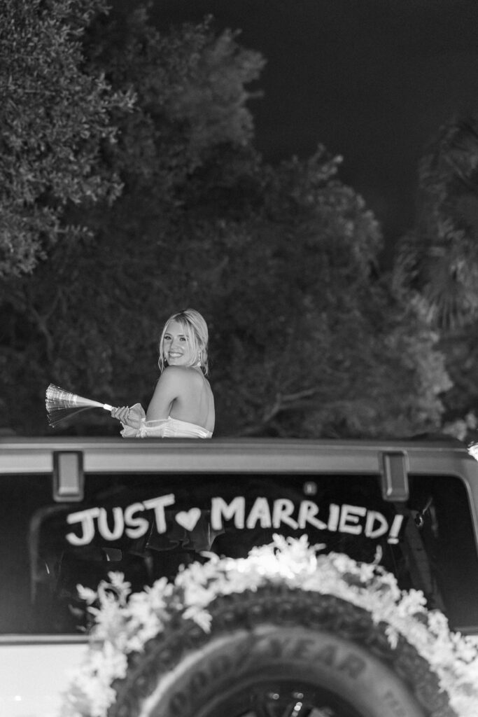 Bride in wedding exit car