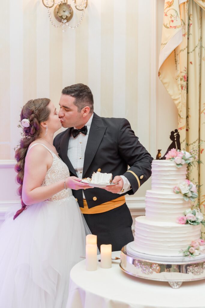 Newly weds kissing and cutting cake