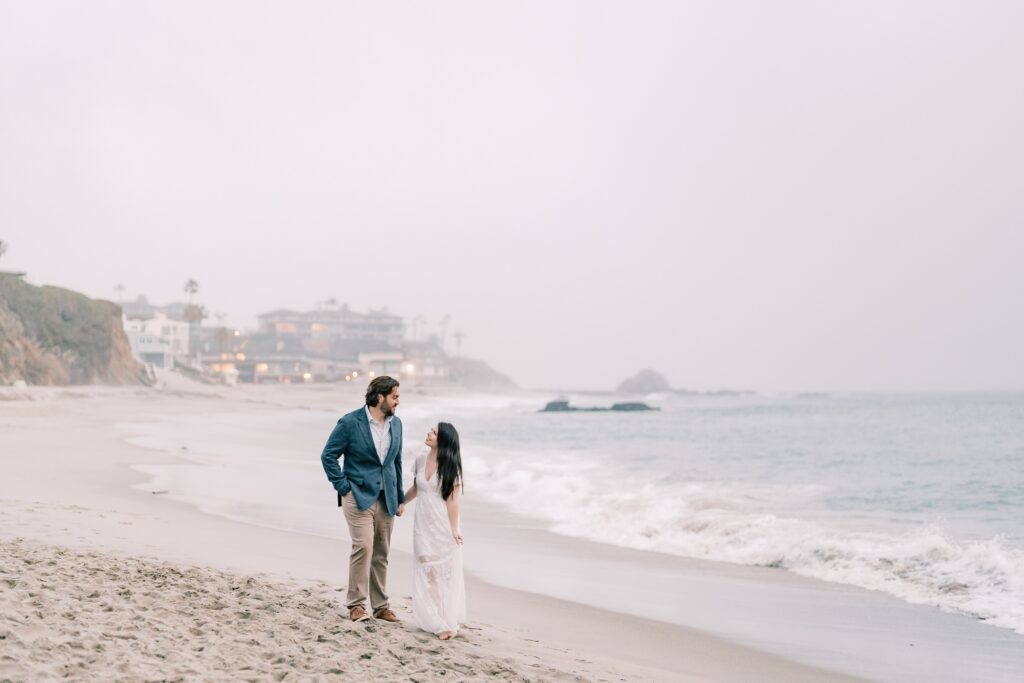 Couple holding hands on Laguna Beach