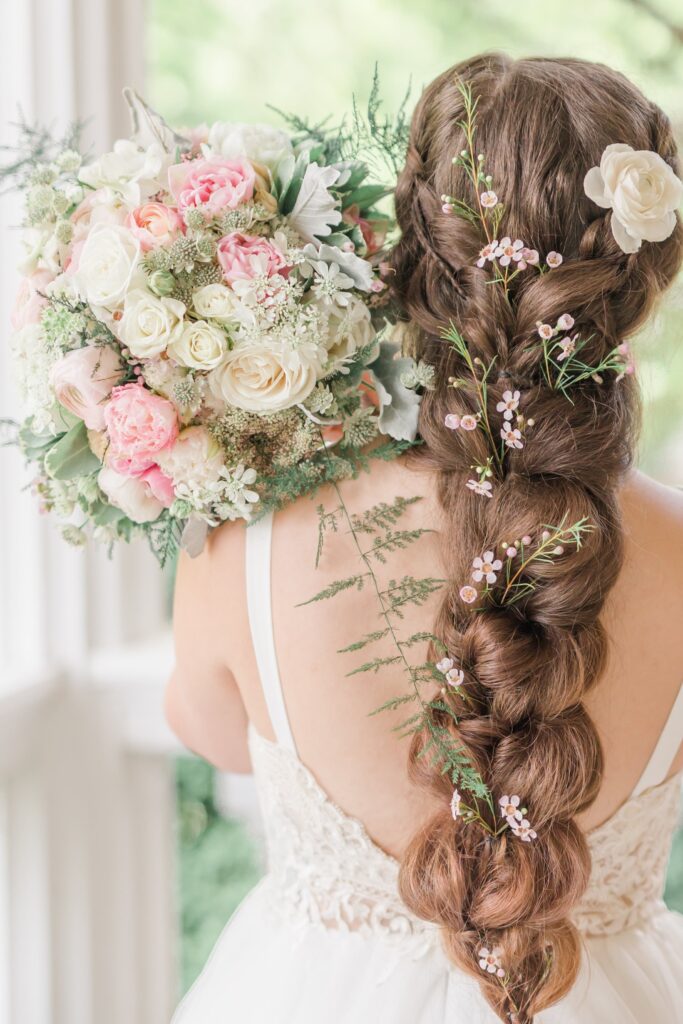 Bride with pink and white bouquet and flowers in her hair
