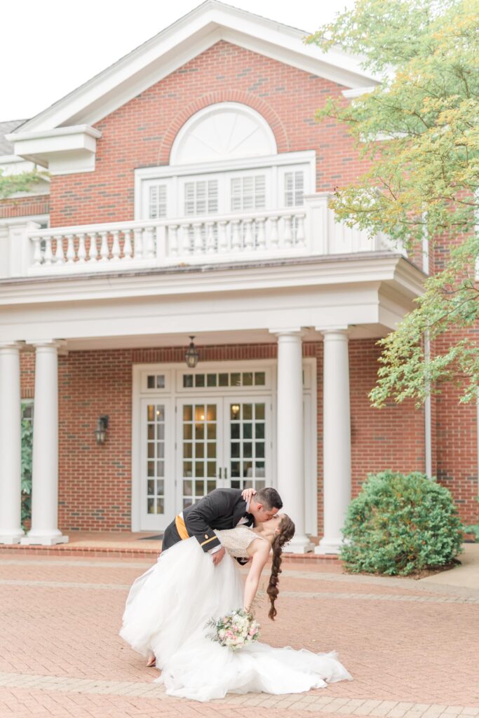 Bride and groom kissing during Jepson Alumni Executive Center wedding portraits